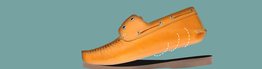 Tan genuine leather boat shoe True Moccasin envelope construction diagram showing leather wrapping beneath foot – TZARO