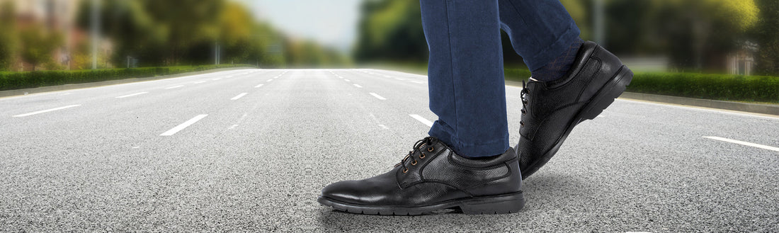 Man walking on road wearing black genuine leather Derby shoes blue jeans mid-stride all-day comfort – TZARO